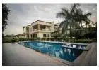 Which are the popular locations for farmhouses in Noida?
